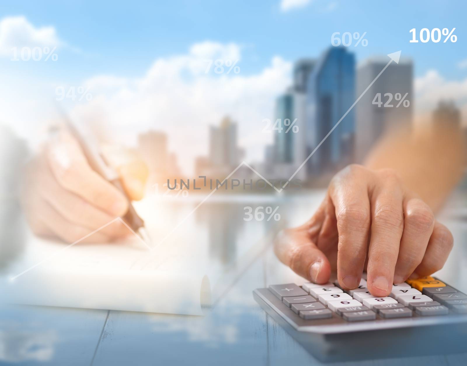 Hand is pressing calculator and write paper, There are overlays of buildings and cities, A concept of business, this image focuses on blurring to be used as the background.