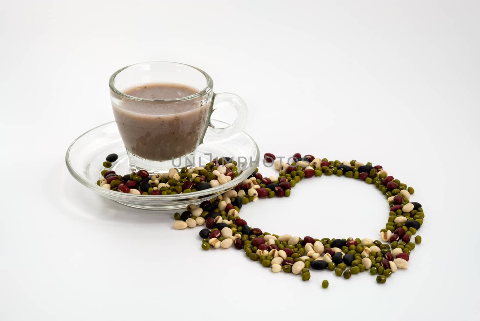 Milk from five kinds of beans isolated on white background, Sprinkle nuts into a heart shape.