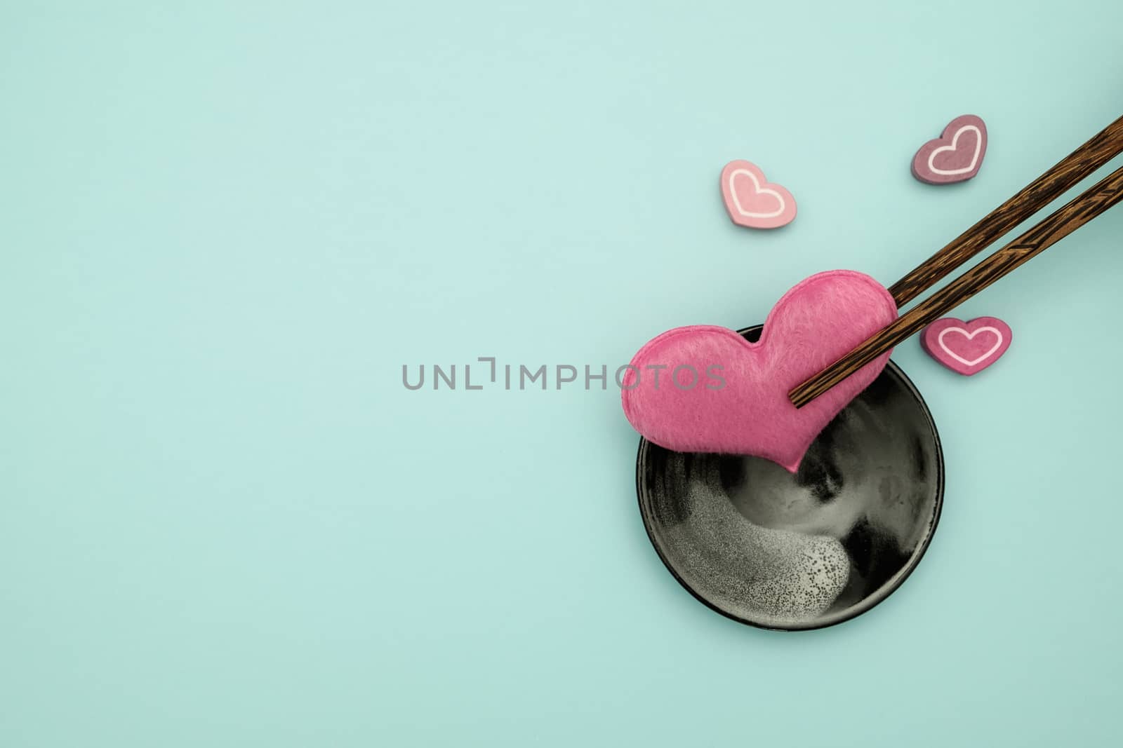 Chopsticks and heart shape on blue background, valentine concept with copy space for write.