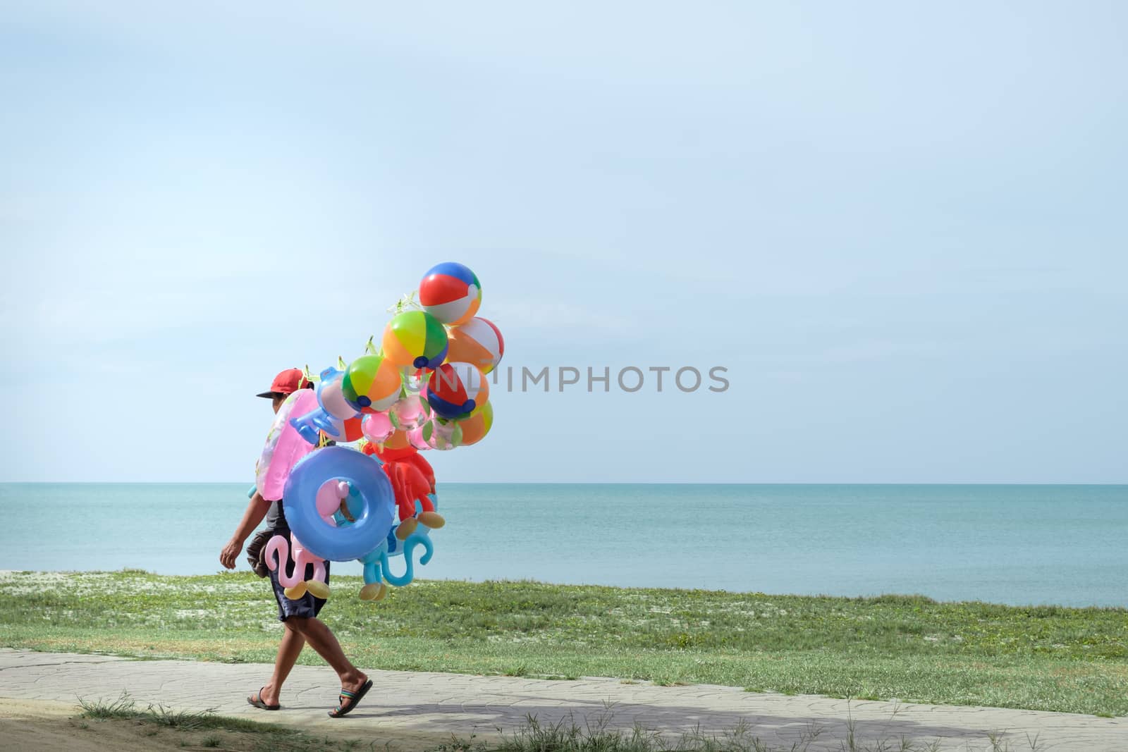 Balloon salesman by the sea with copy space to write.