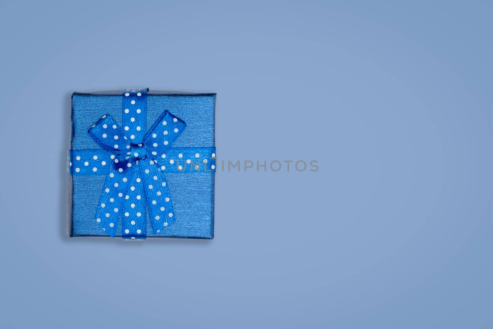 Top view of blue gift box on bluebackground. with copy space for text.