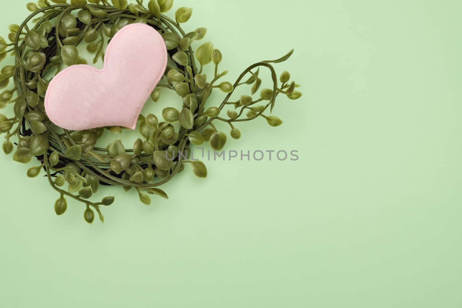 bouquet of leaves and heart shape on green background with valentine concept.