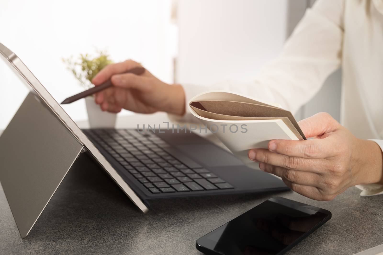 Hand holding a stylus pen And is working on the design of the notebook screen. Graphic designer is drawing pictures by a digital pen.