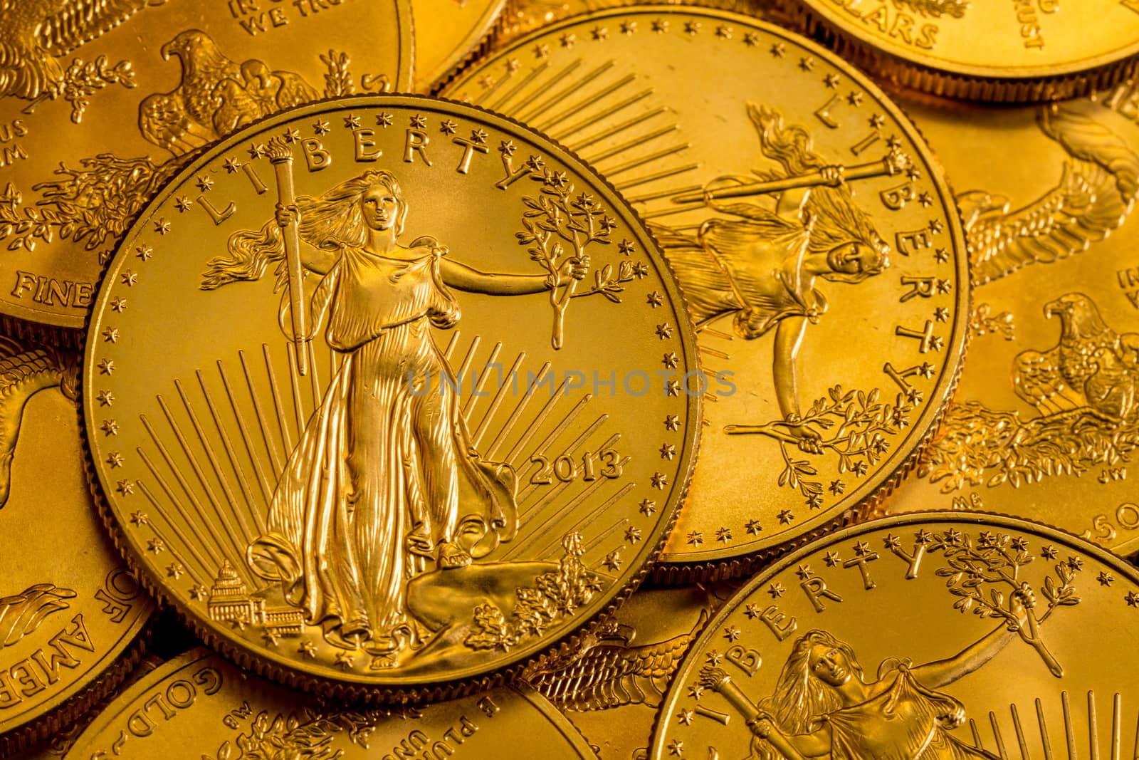 Pile of golden coins with Liberty on US Treasury issue Gold Eagle one ounce pure gold coin
