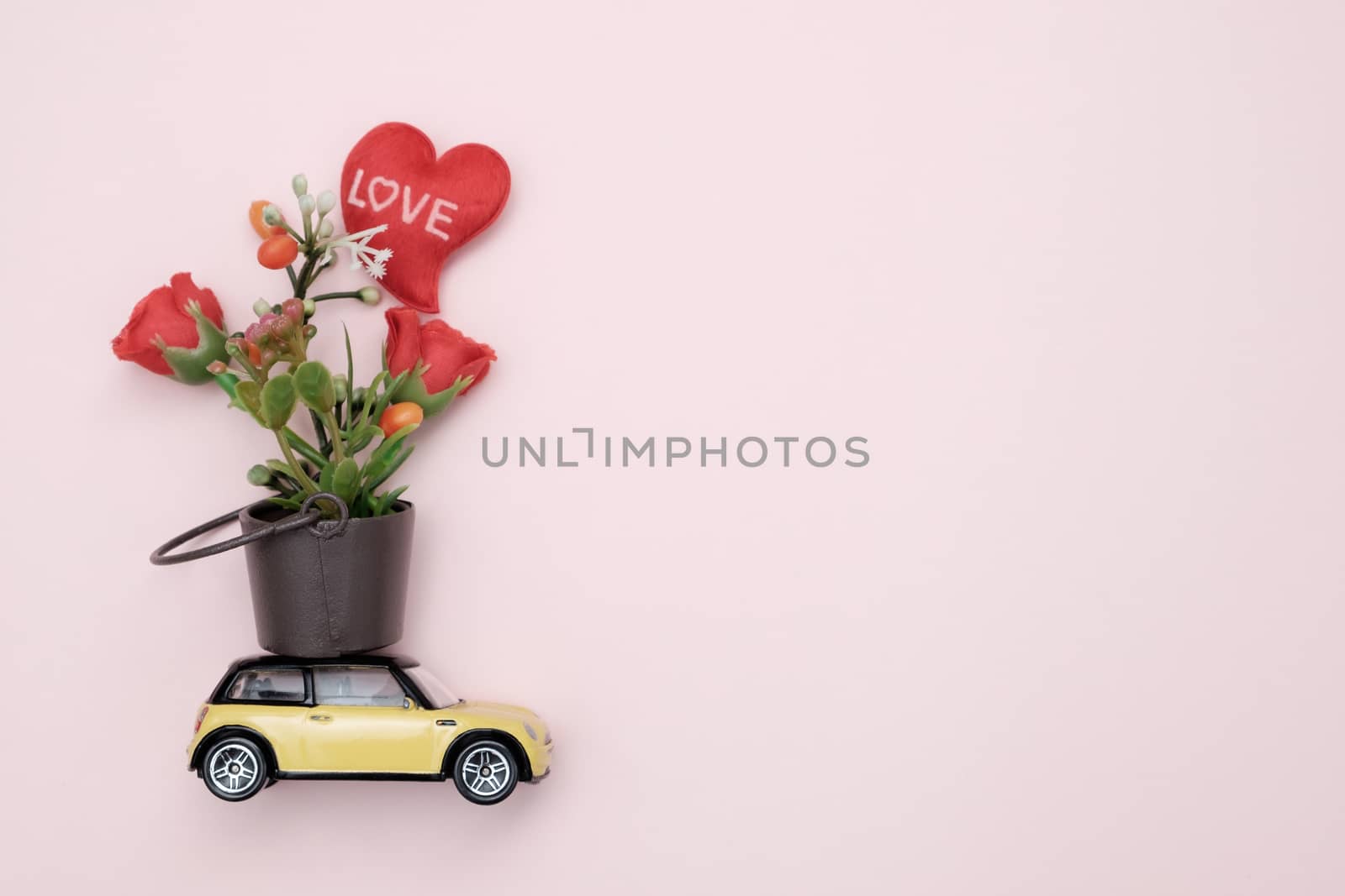 Toy car carrying flower in tha tank, Concept of valentine day, AF point selection.