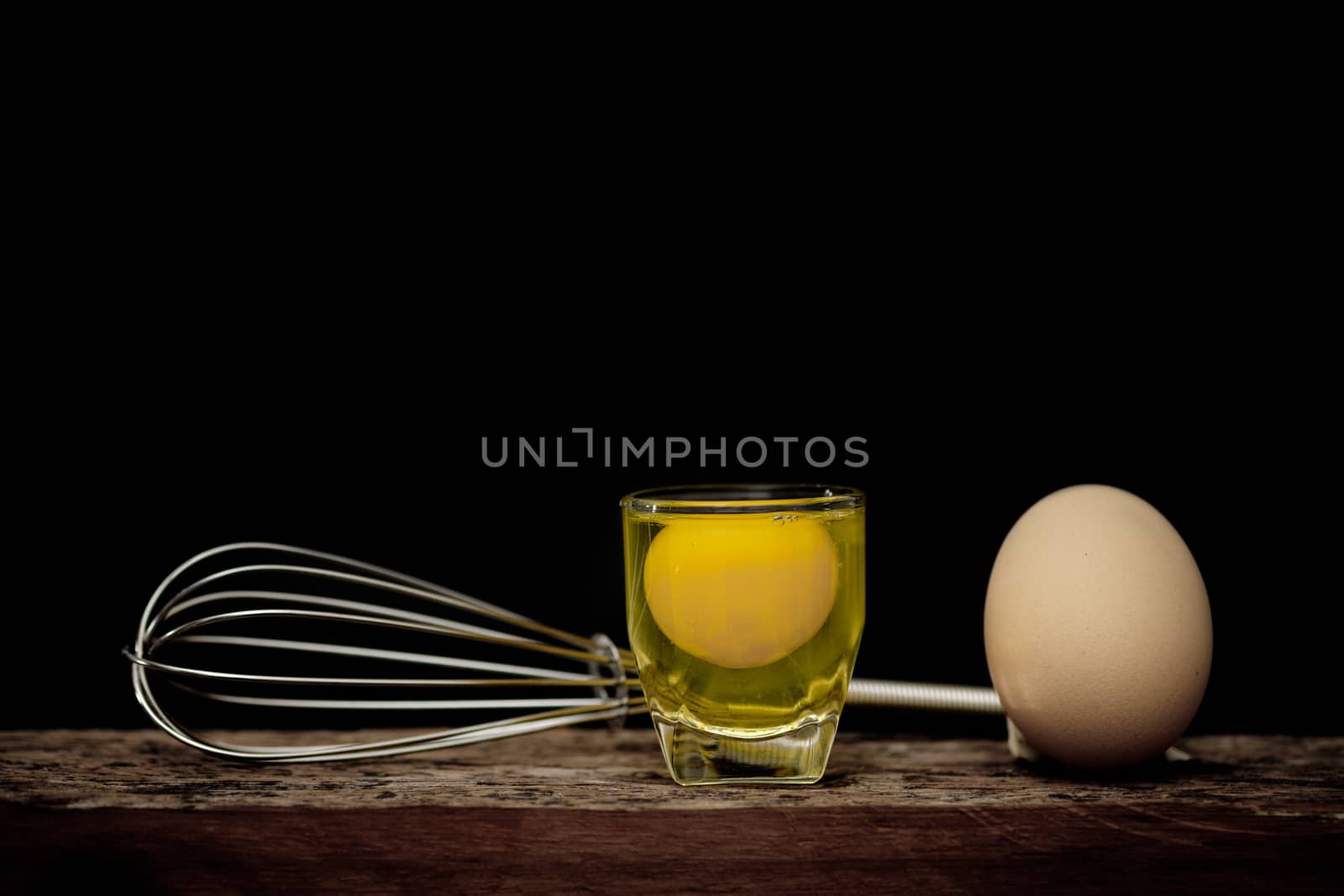 Still life-Eggs and yolks in glass arranged in a black scene, Egg is beneficial to the body, Food concept. dark tone.