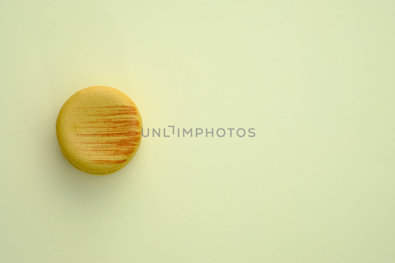 Macaroon on a yellow background. Topview, Space to write at right.