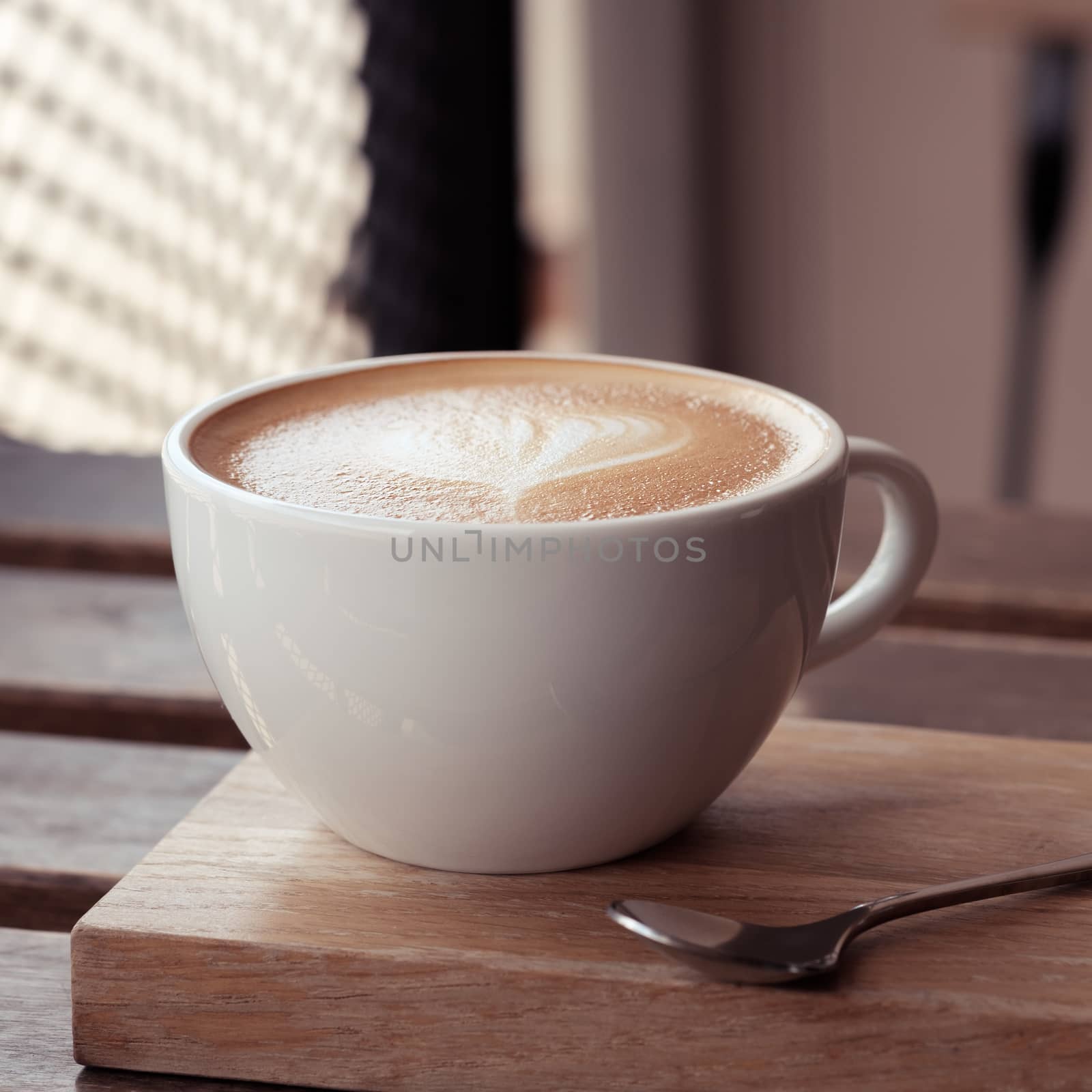 Hot coffee in a glass of white ceramic put on wooden board with copy space to write. Classic chrome and vintage stlye.