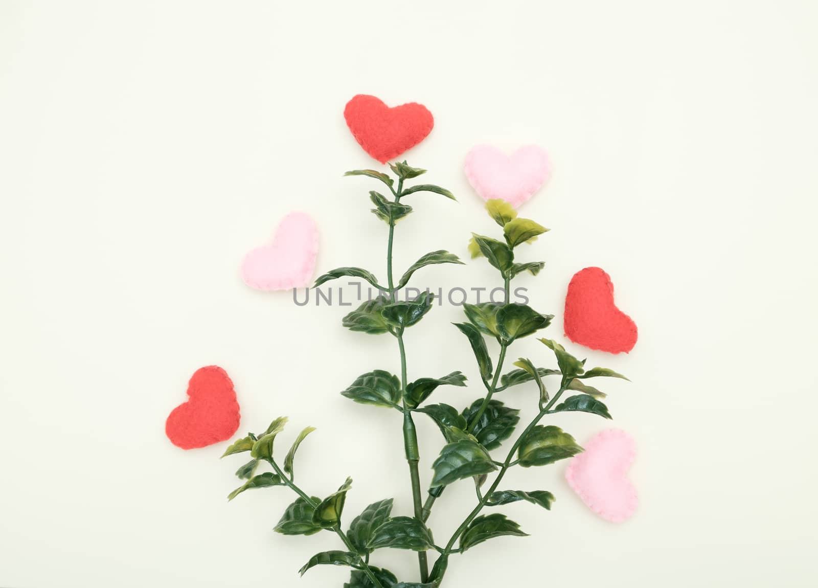 Plastic tree and many heart-shaped  on yellow background with copy space for write and valentine concept.