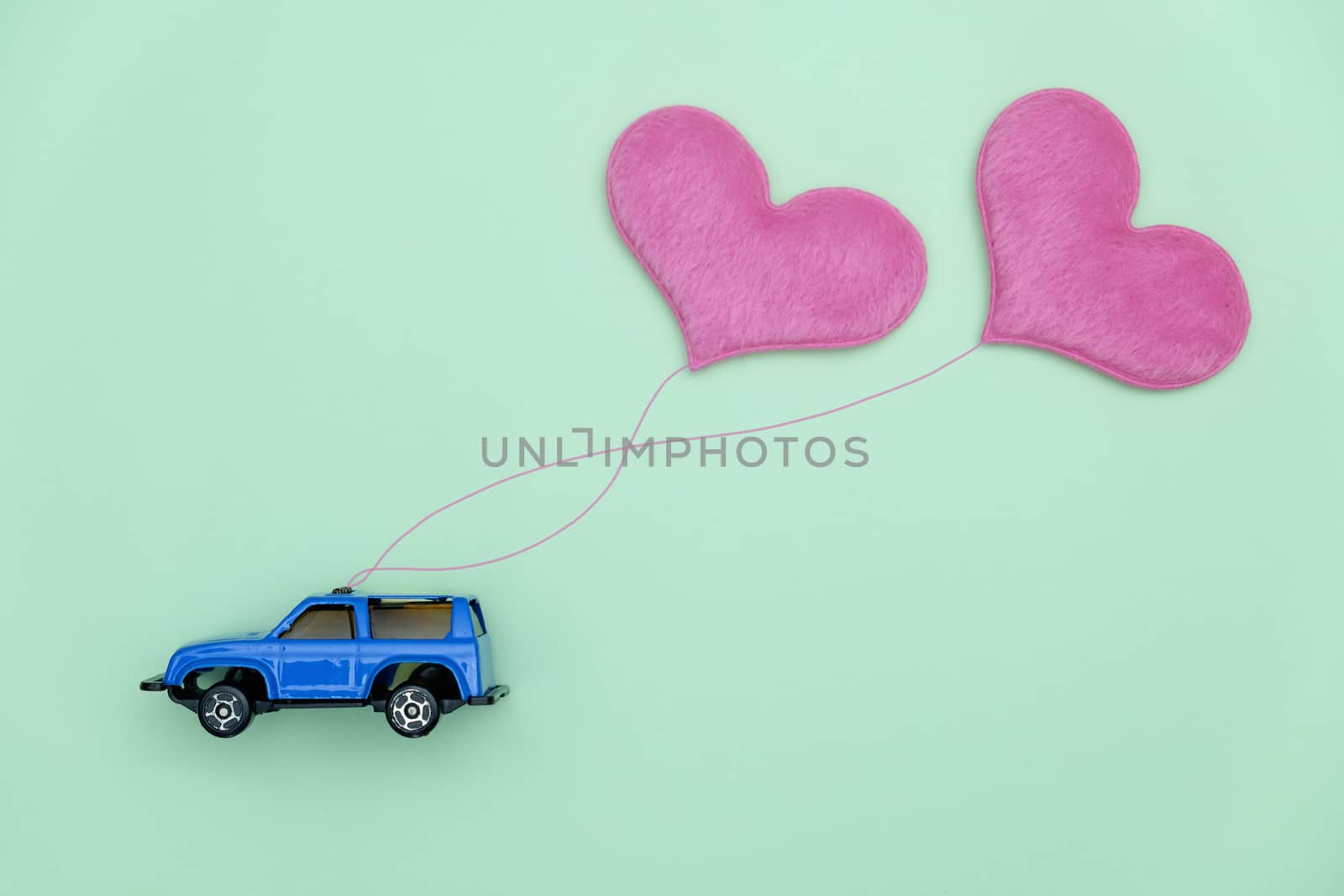 Toy car carrying heart-shape balloon, Concept of valentine day.