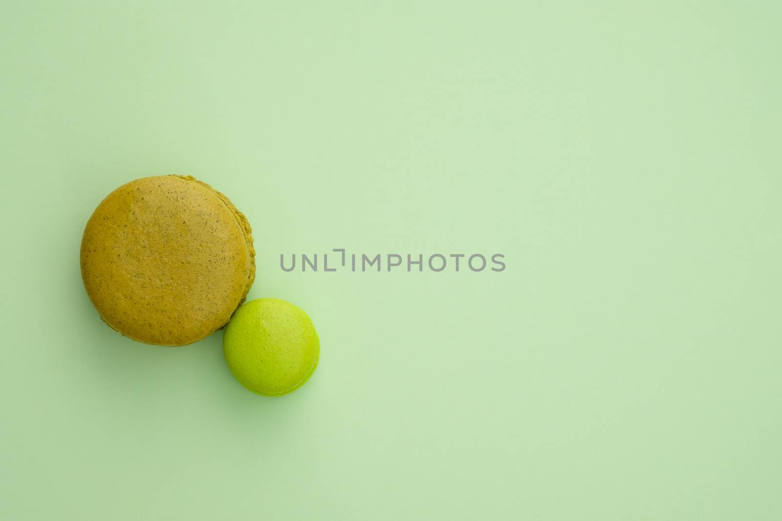 Macaroon on a green background. Top view, Space to write at right.