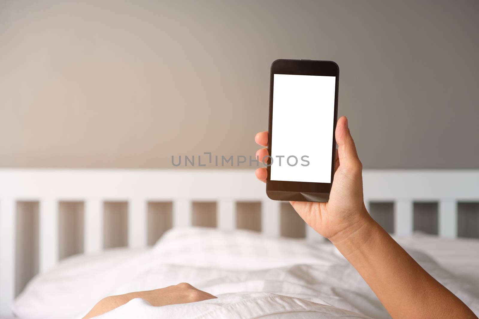 Woman's hands using  smartphone with blank screen in the morning.
