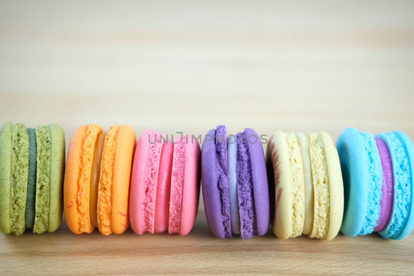 Sweet and colorful, Different kinds of macaroons in stack on light wooden background with blank space,selective focus, Dessert.