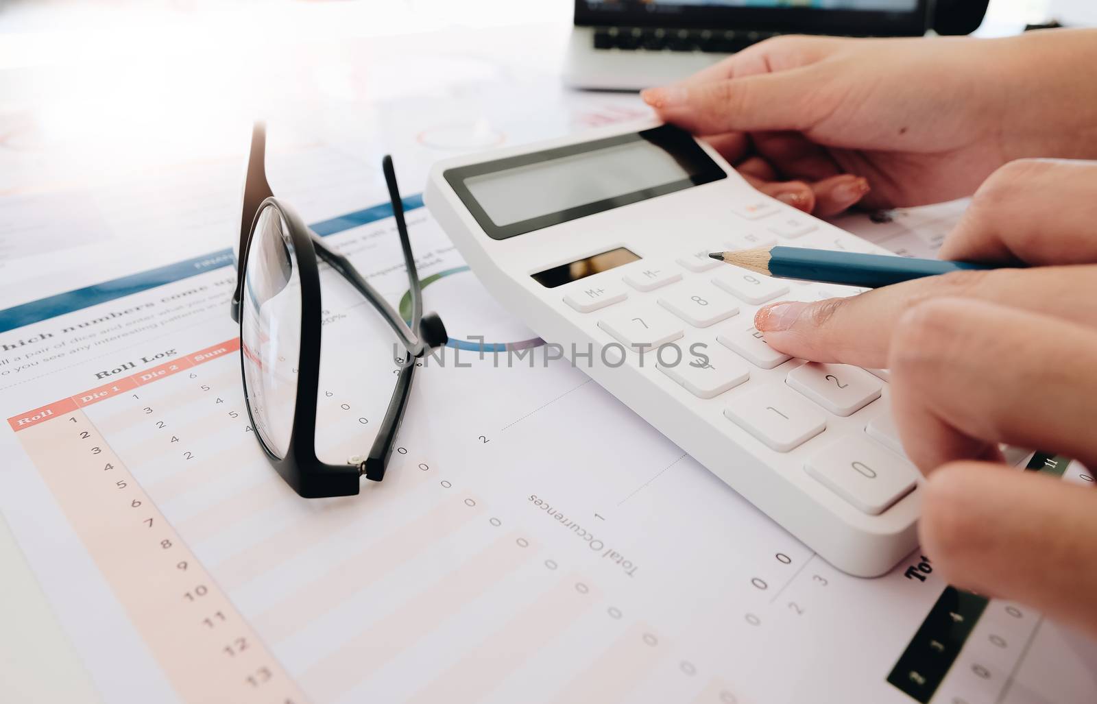 Close up Business woman using calculator and laptop for do math finance by nateemee
