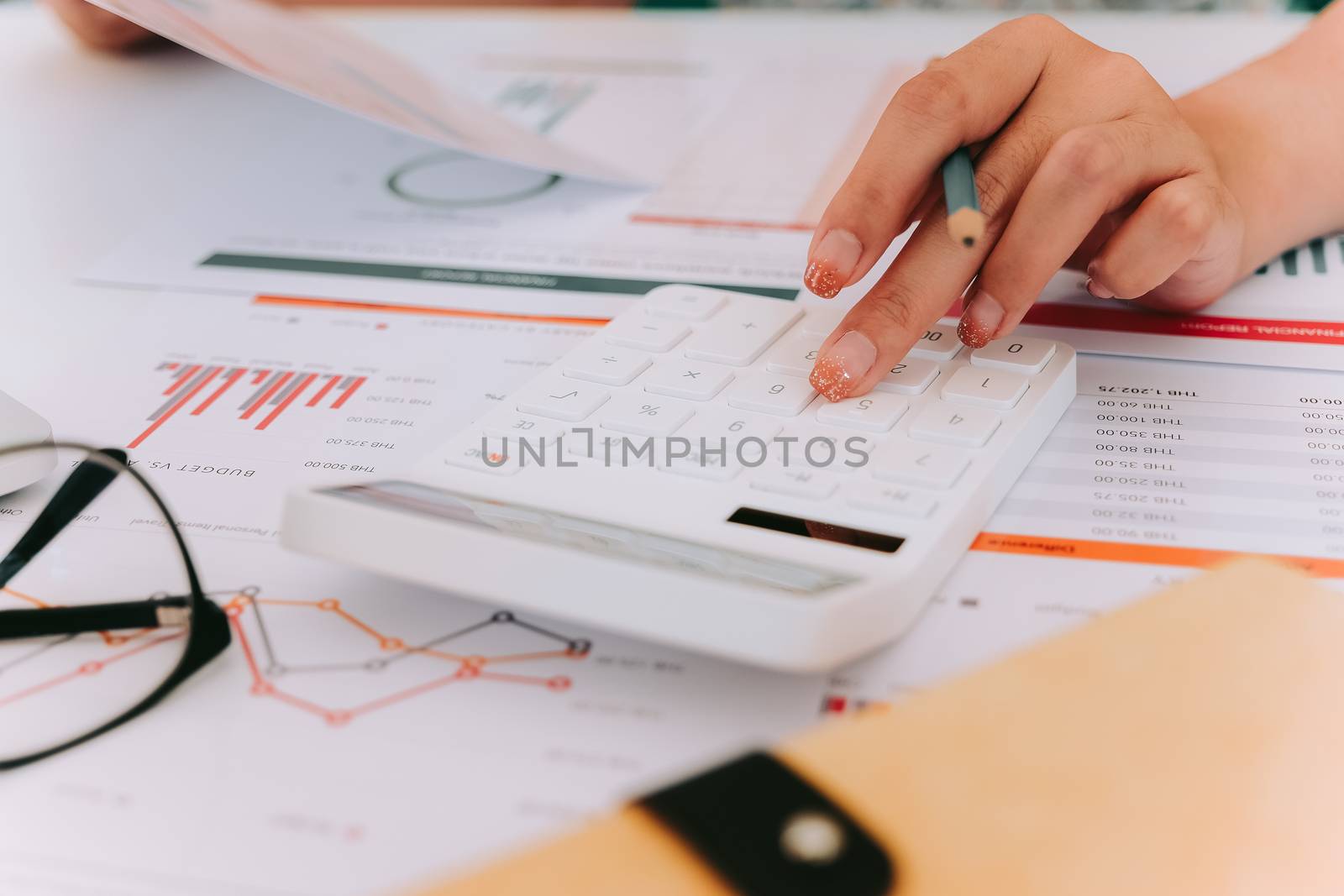 Close up Accountants use calculator analysis financial from financial statement reports.