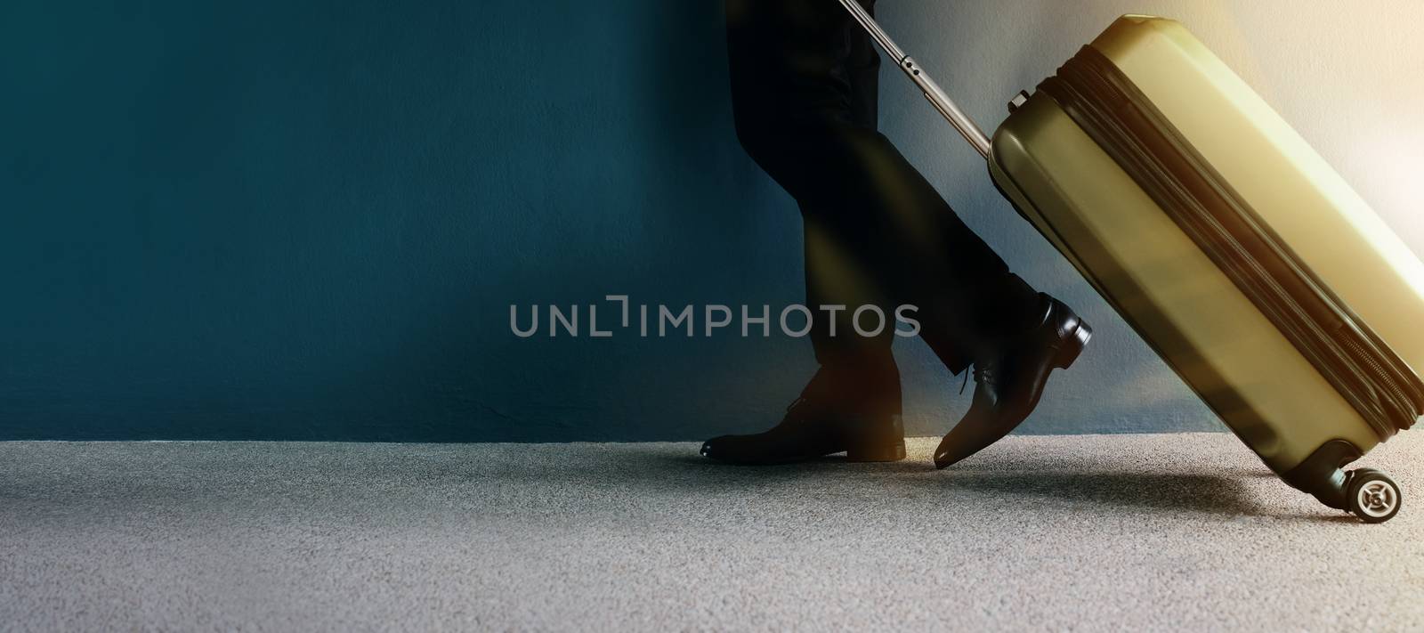 Business Trip or Travel Concept. Businessman in Formal Working Dress Walking with Suitcase by the Wall inside airport Departures Terminal, Side view