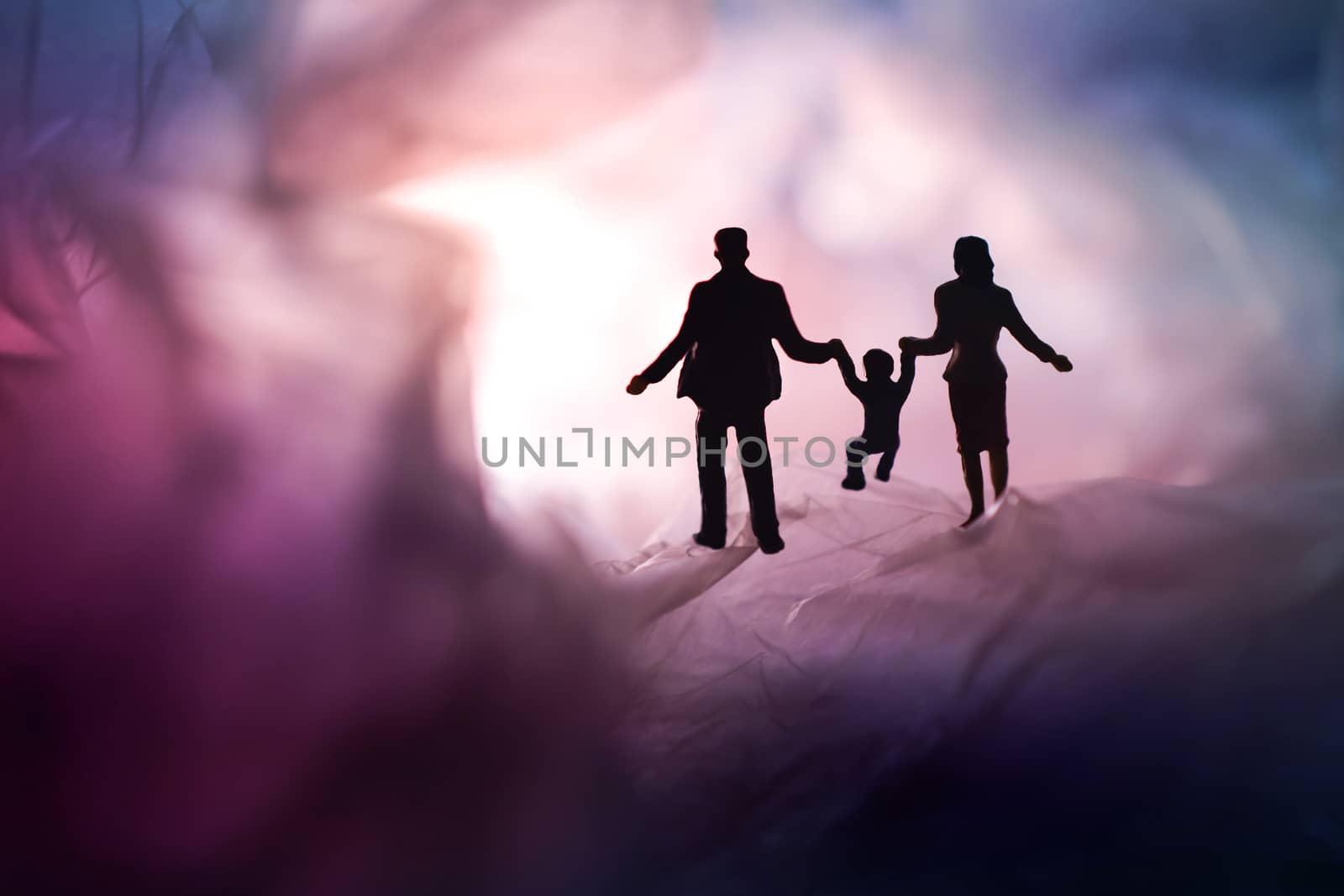 Love and Happy Family. Exploration for Children and Parent. Miniature of Father, Mother and Son holding Hands and Walking on a Mystery Dark Place