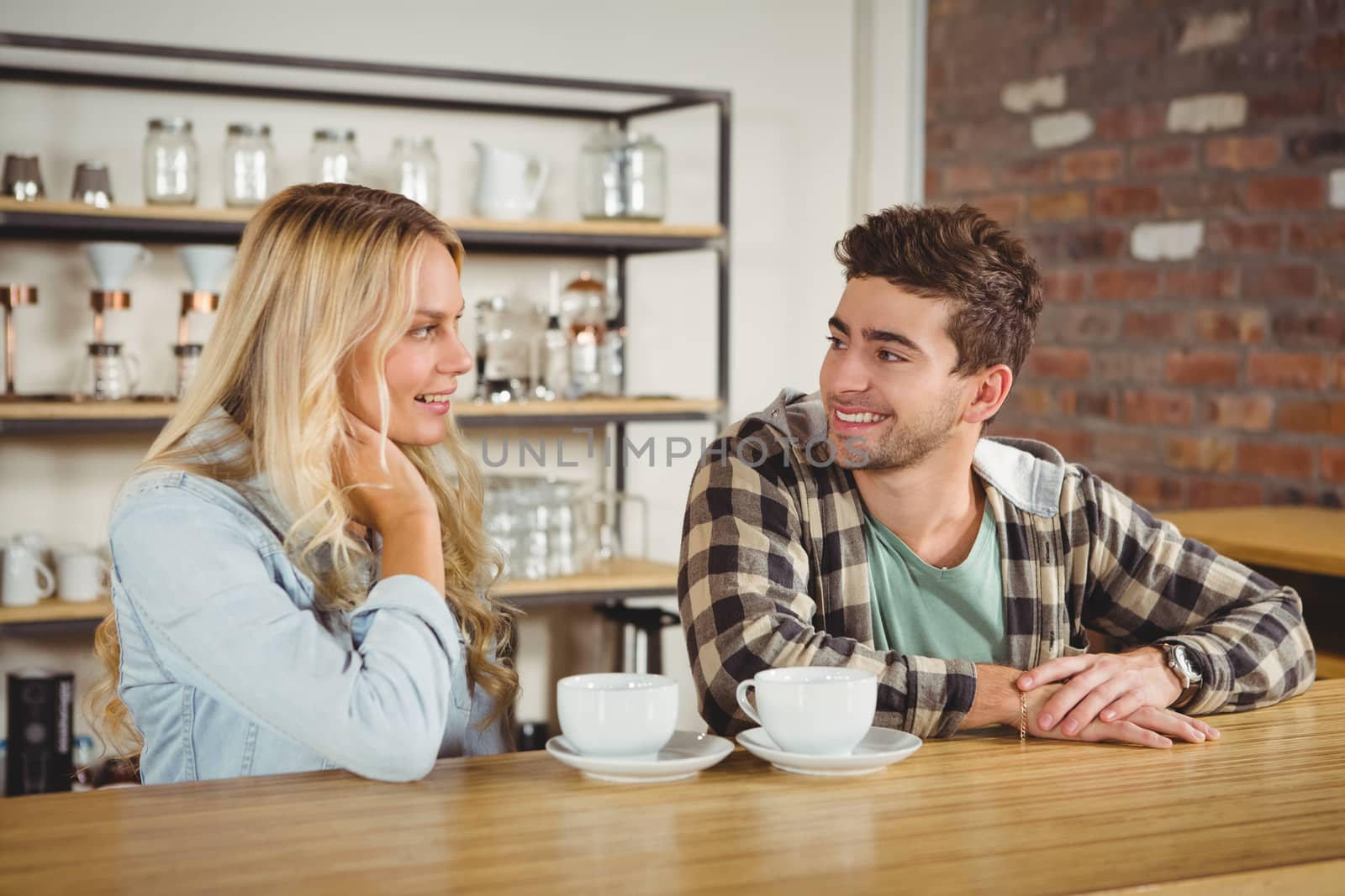 Smiling hipster sitting and talking by Wavebreakmedia