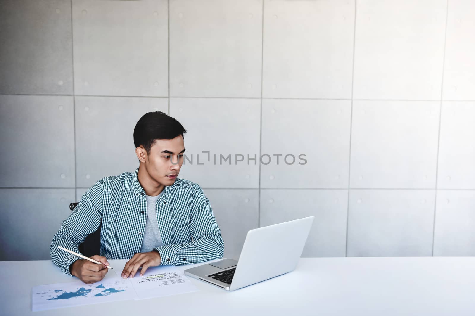 Young Businessman Working on Computer Laptop in Office. Wide Shot
