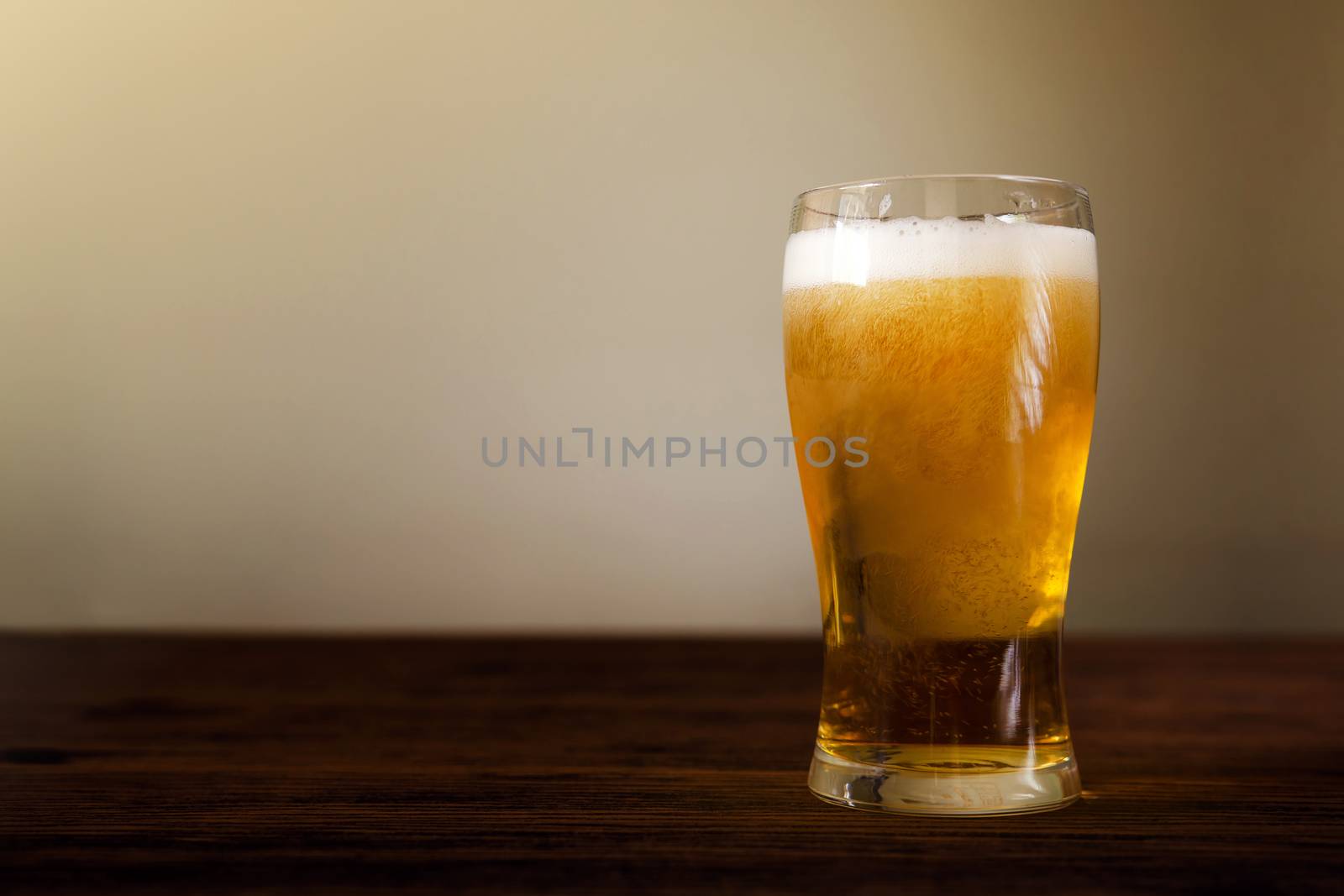 Glass of Beer on Wooden Table. Front View. Shot with Natural Daylight
