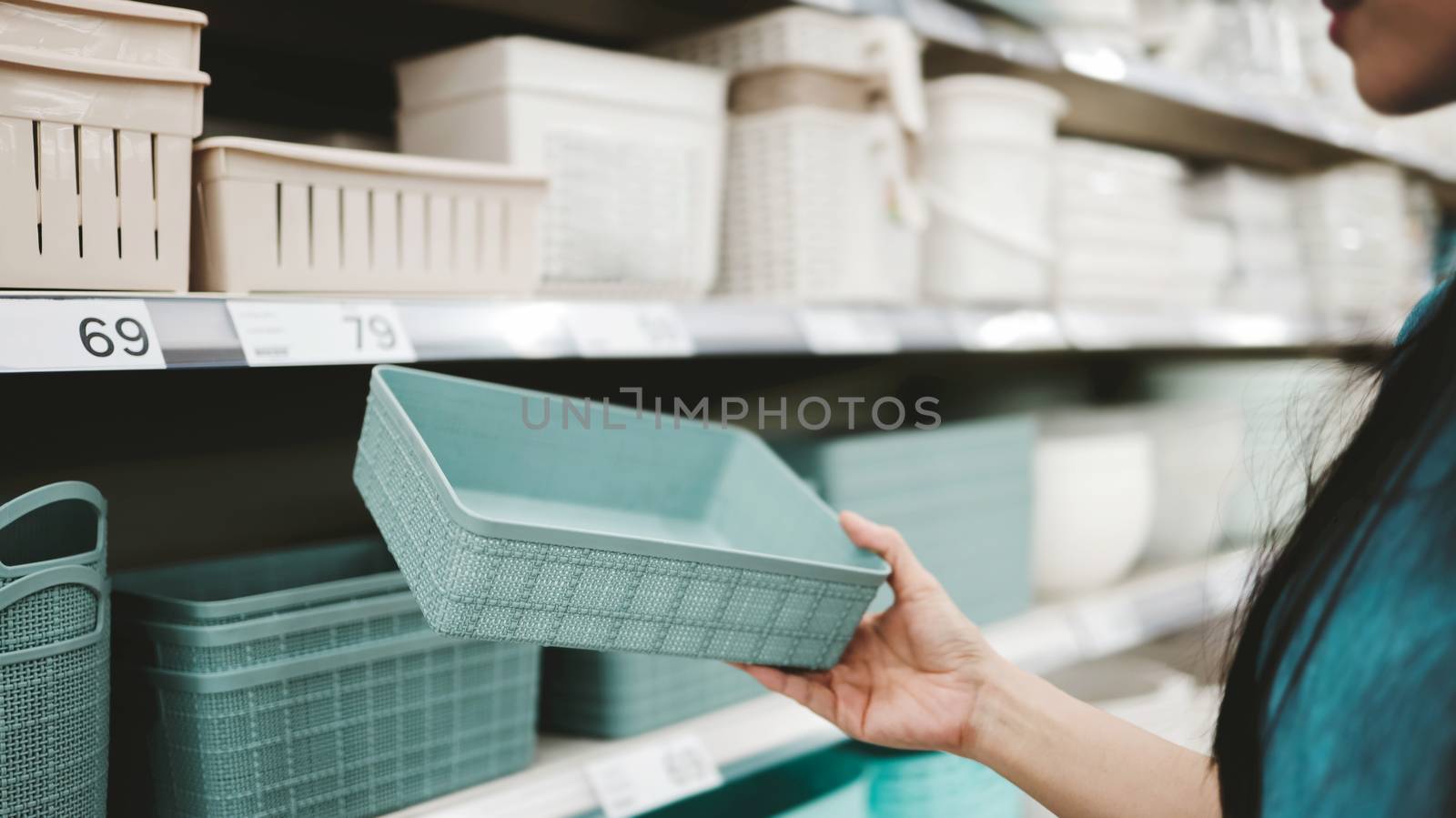 Young Woman Customer Choosing Plastic Product in Department Stor by Black-Salmon