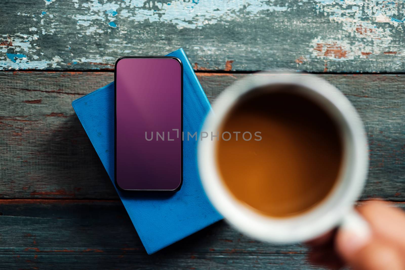 Smartphone Mockup Image with Clipping Path. Using Mobile Phone while Drinking Coffee and Reading Book