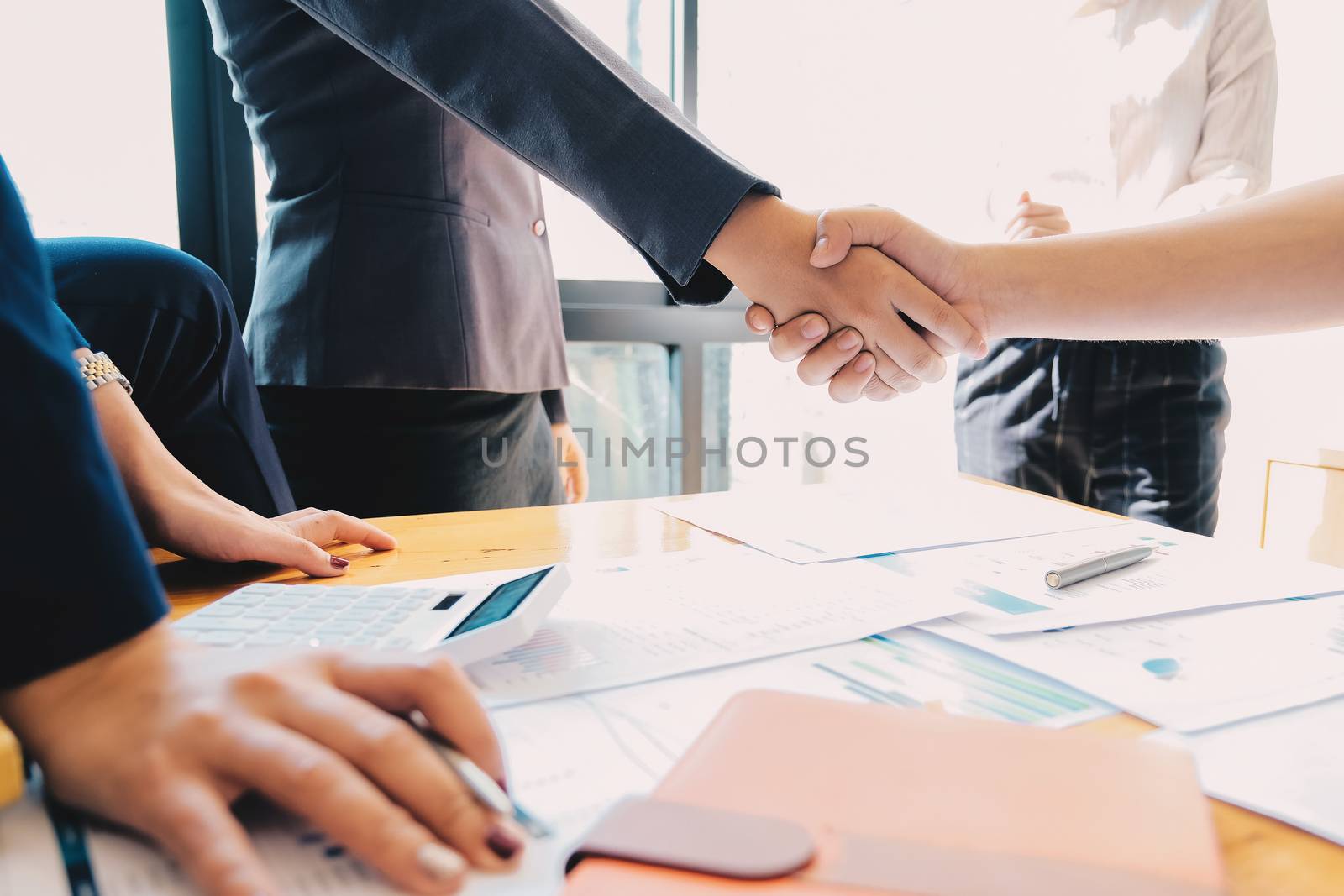 Business people shaking hands, finishing up meeting, business etiquette, congratulation, merger and acquisition concept.