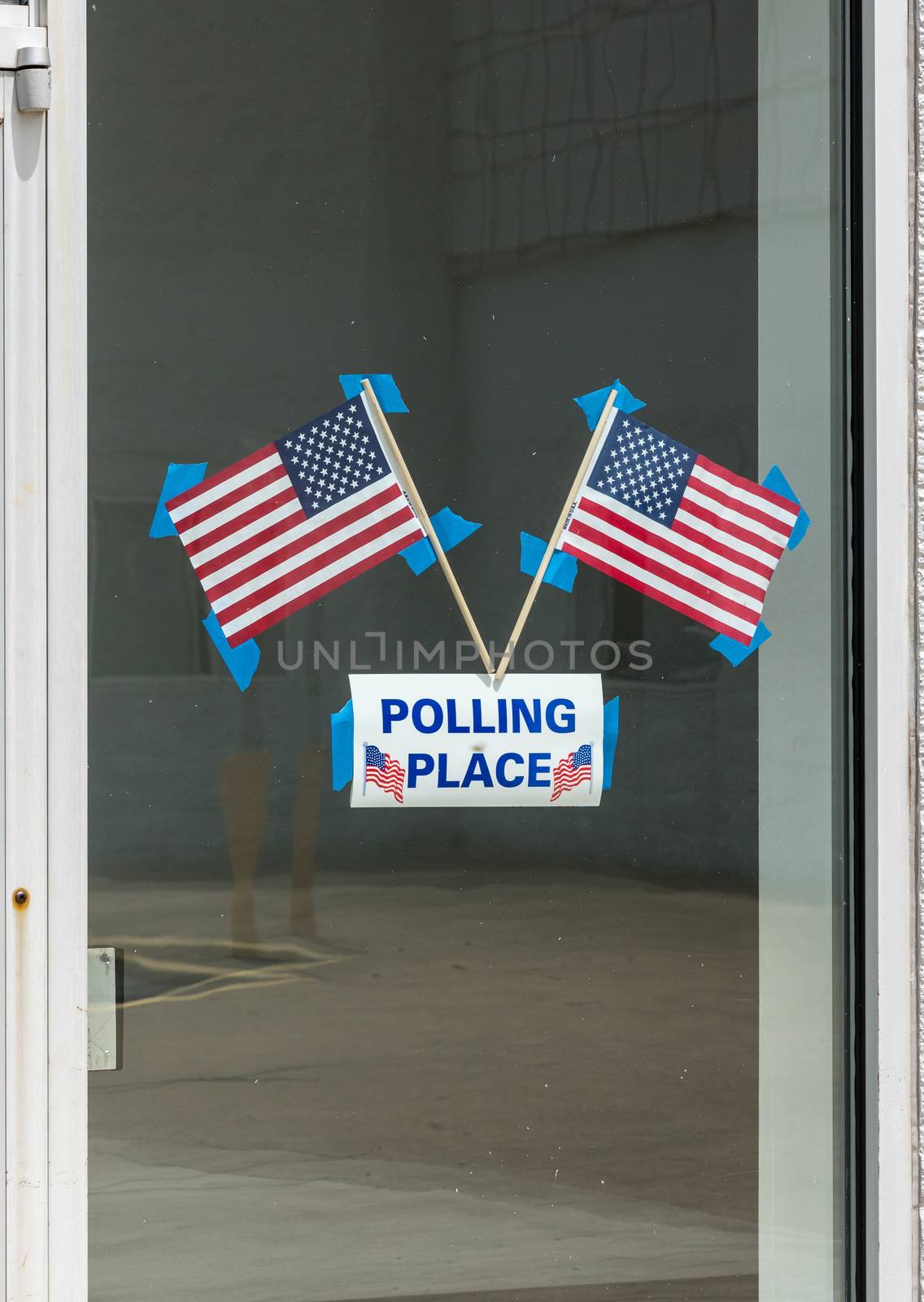 USA flags stuck to window of Polling place for early voting in the USA elections
