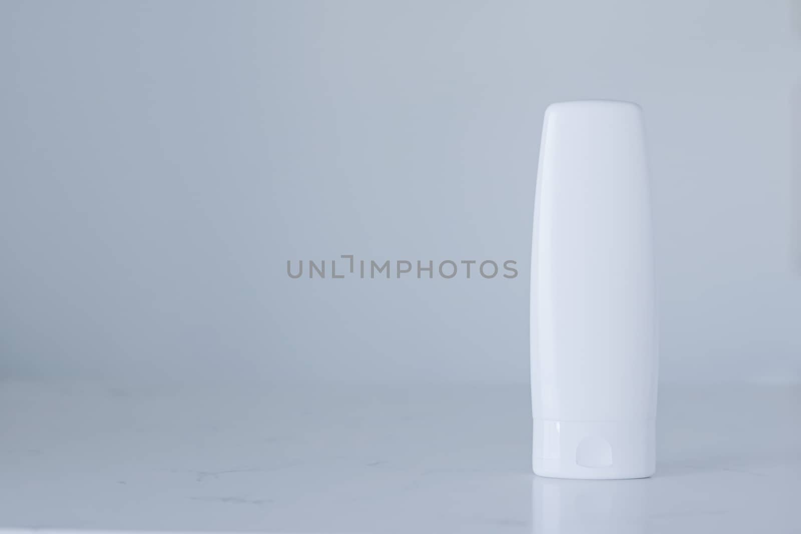 Blank label cosmetic container bottle as product mockup on gray background, hygiene and healthcare