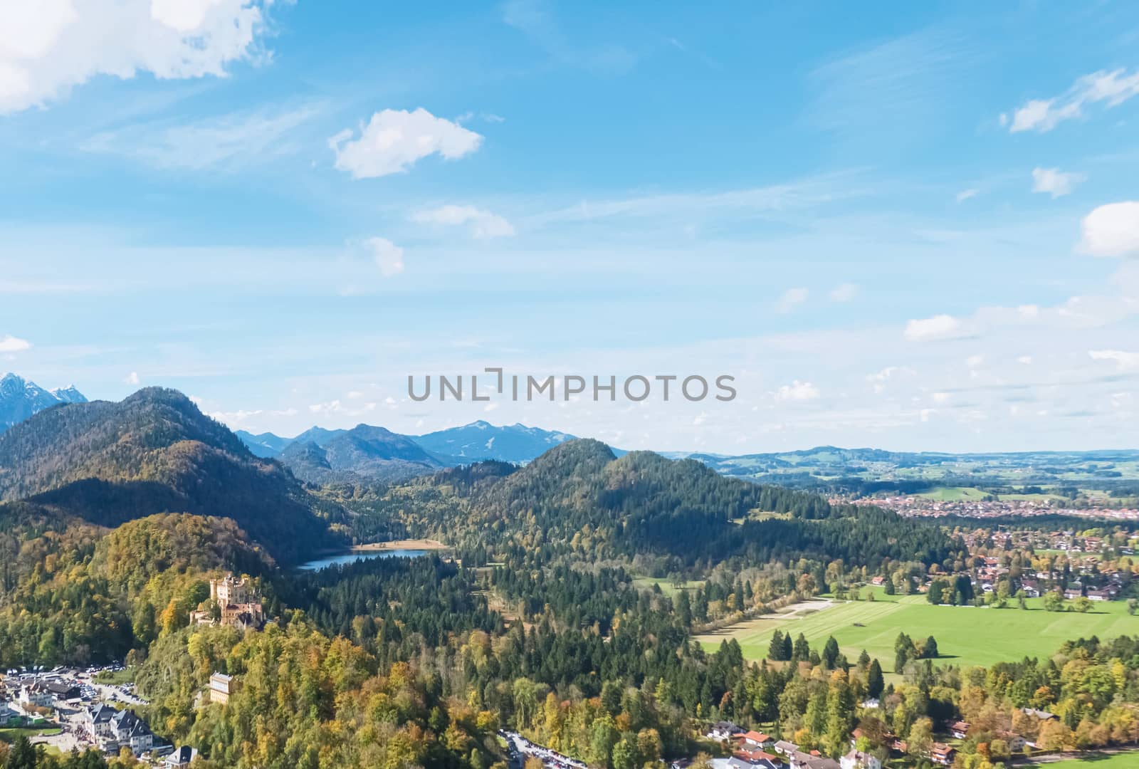 Beautiful nature of European Alps, landscape view of alpine mountains, lake and village on a sunny day, travel and destination scenery