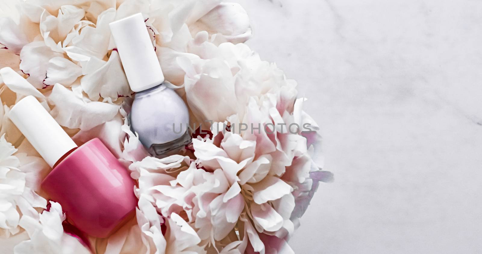 Nail polish bottles on floral background, french manicure and cosmetic branding design