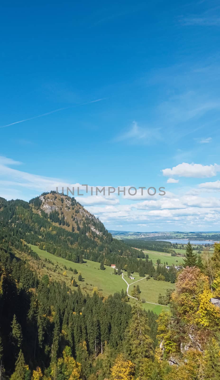 Beautiful nature of European Alps, landscape view of alpine mountains, lake and village on a sunny day, travel and destination scenery