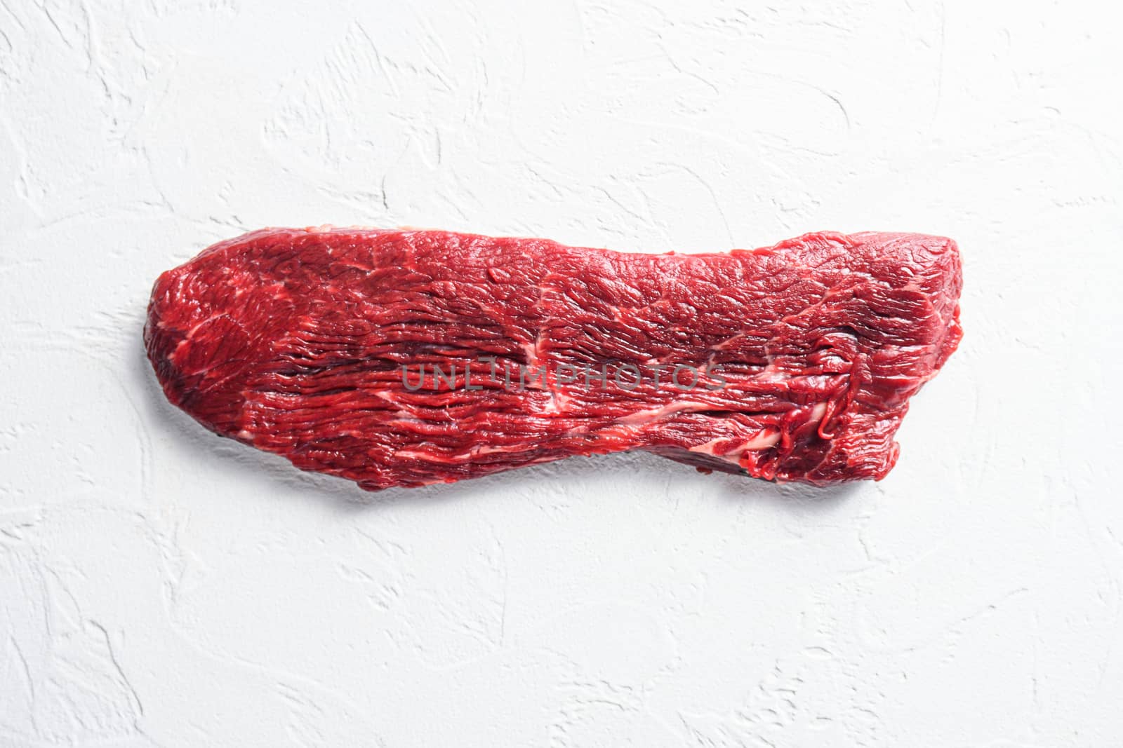 Raw tri tip, bottom sirloin steak on a white stone background top view by Ilianesolenyi