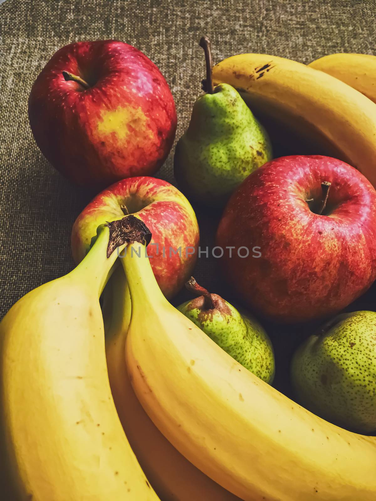 Organic apples, pears and bananas on rustic linen background by Anneleven