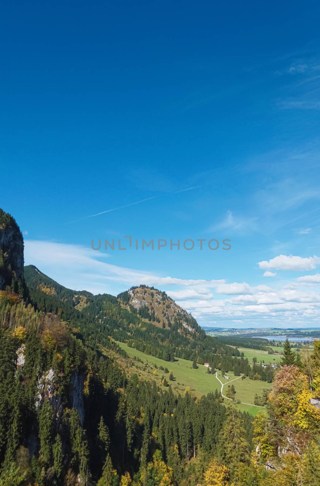 Beautiful nature of European Alps, landscape view of alpine mountains, lake and village on a sunny day, travel and destination scenery