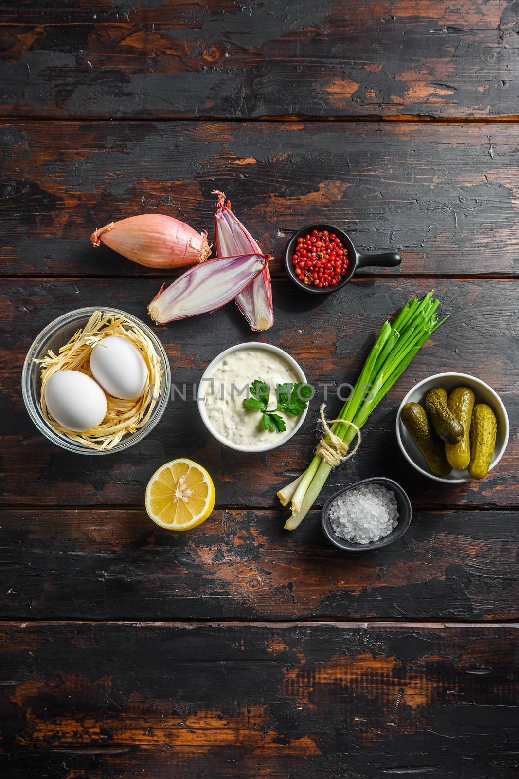 Organic lemon ranch dressing Tartar sauce. With ingredients capers, cucumbers, parsley, lemon and eggs. Top view over dark wood rustic old surface overhead vertical composition by Ilianesolenyi