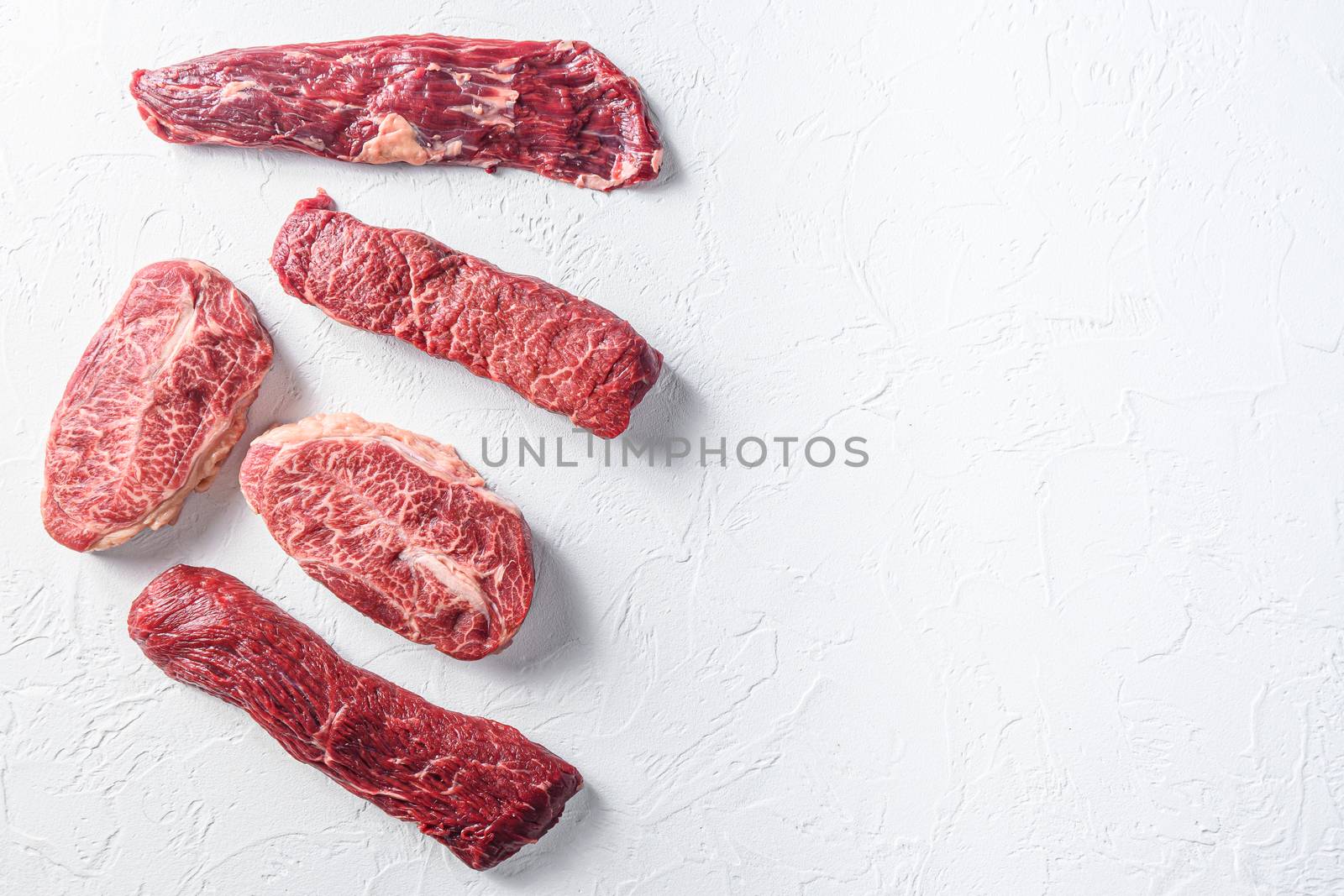 Set of denver, top blade, tri tip steak, machete, flank, bavette London broil marble beef on white background top view space for text.