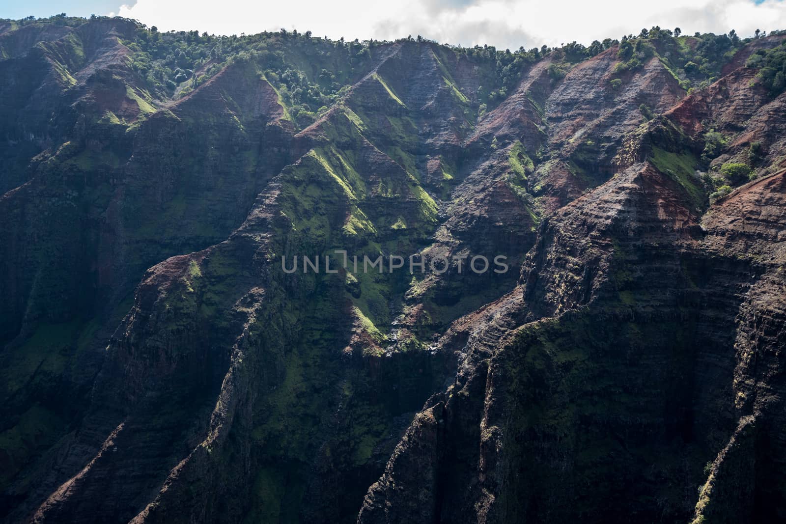 Aerial view of Waimea Canyon and landscape of hawaiian island of Kauai from helicopter flight