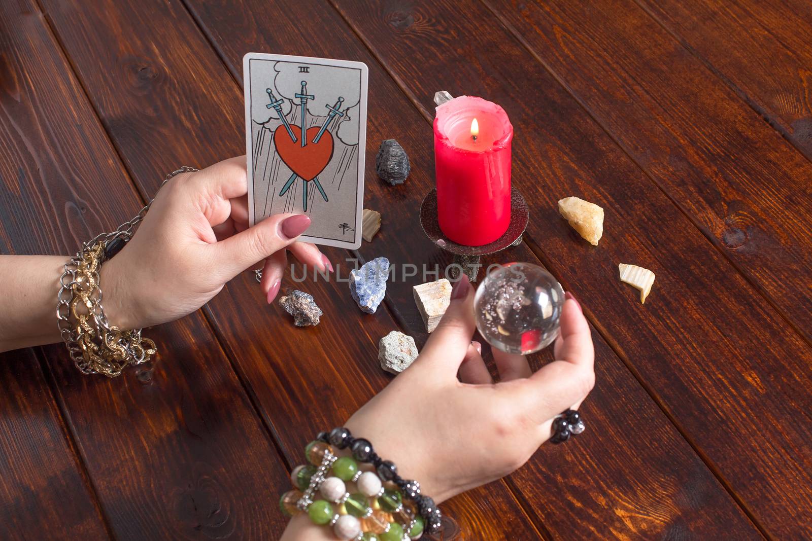 Bangkok, Thailand, March.15.20.A fortune teller holds a magic ball and a Tarot card with a heart.The Gypsy lays out Tarot cards and guesses for the future.Magical sessions with the cards.Clairvoyance