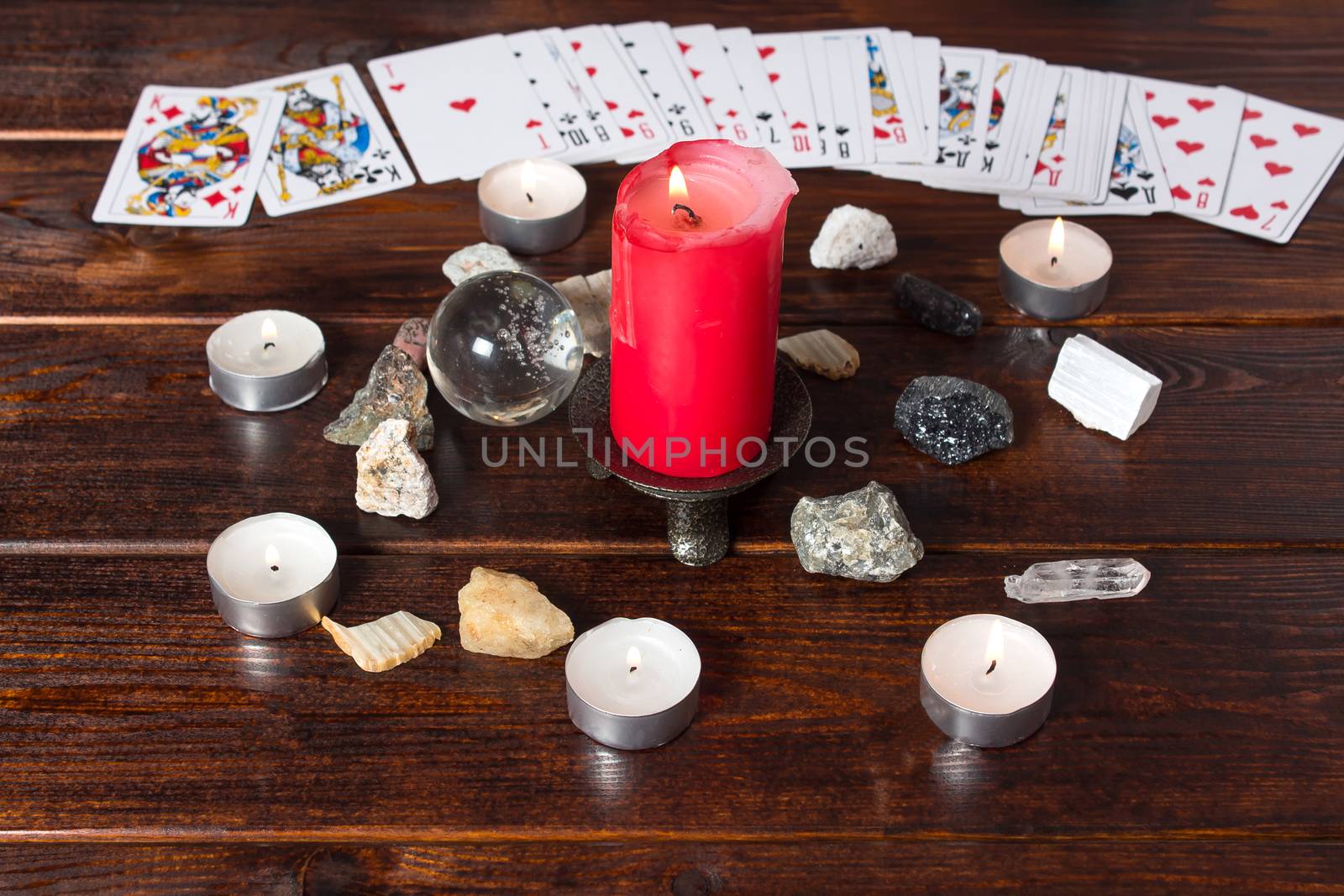 Bangkok, Thailand, March.15.20.On the table are fortune-telling cards, a magic ball, magic crystals and a lighted candle.Magic sessions with clairvoyance cards. Card reading by candlelight