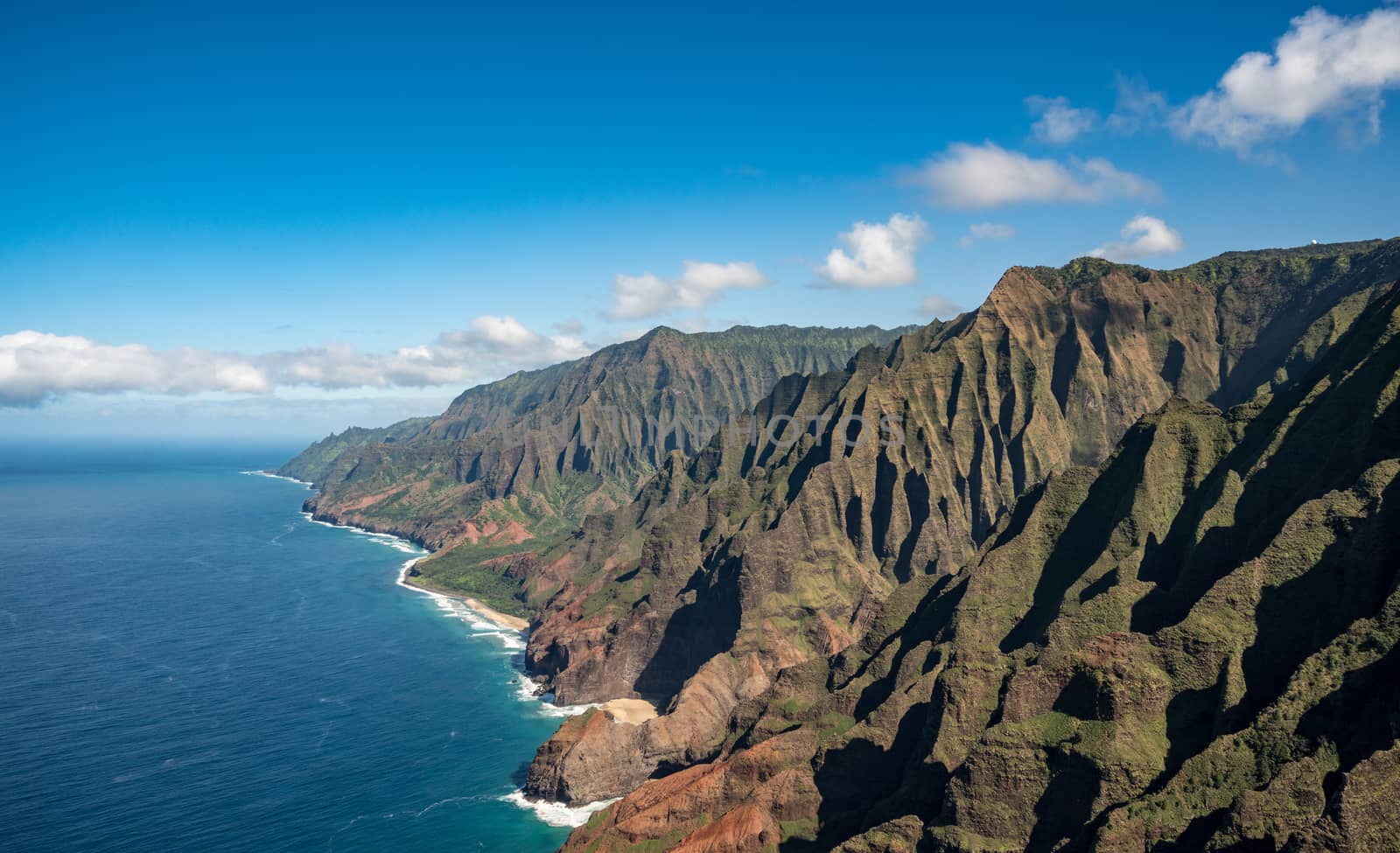Aerial view of Na Pali coastline and landscape of hawaiian island of Kauai from helicopter flight