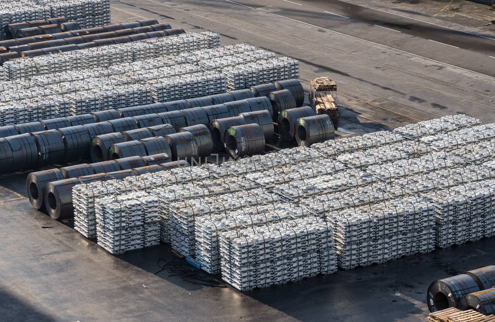 Ingots of aluminum and rolls of steel line the quayside in the Port of Koper in Slovenia