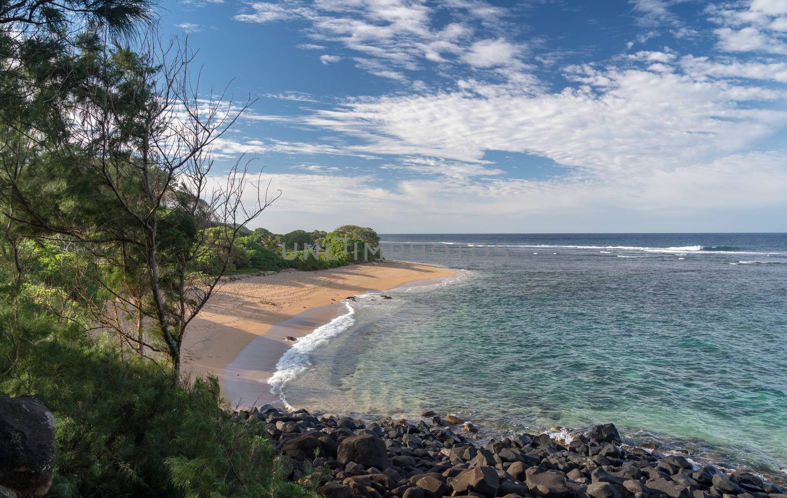Deserted sandy Larsen's Beach near Pakala point on Kauai