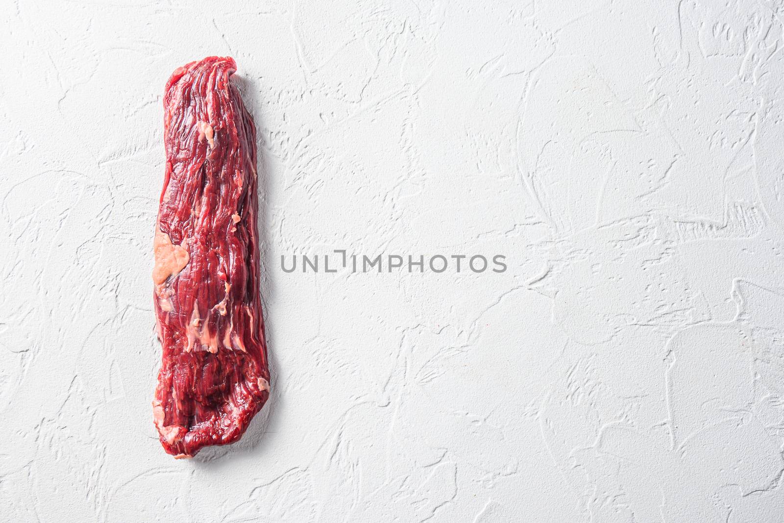 Raw skirt, machete steak on a white stone background space for text