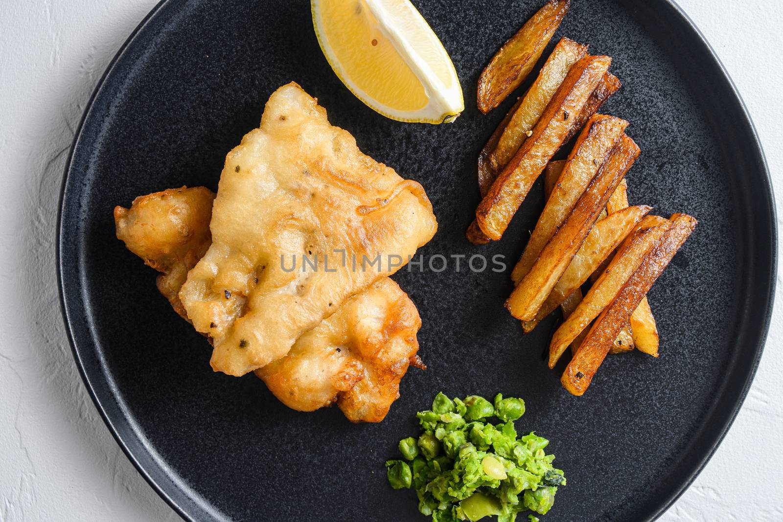 English traditional food fish and chips with peas and a slice of lemon view from above, close-up detail by Ilianesolenyi