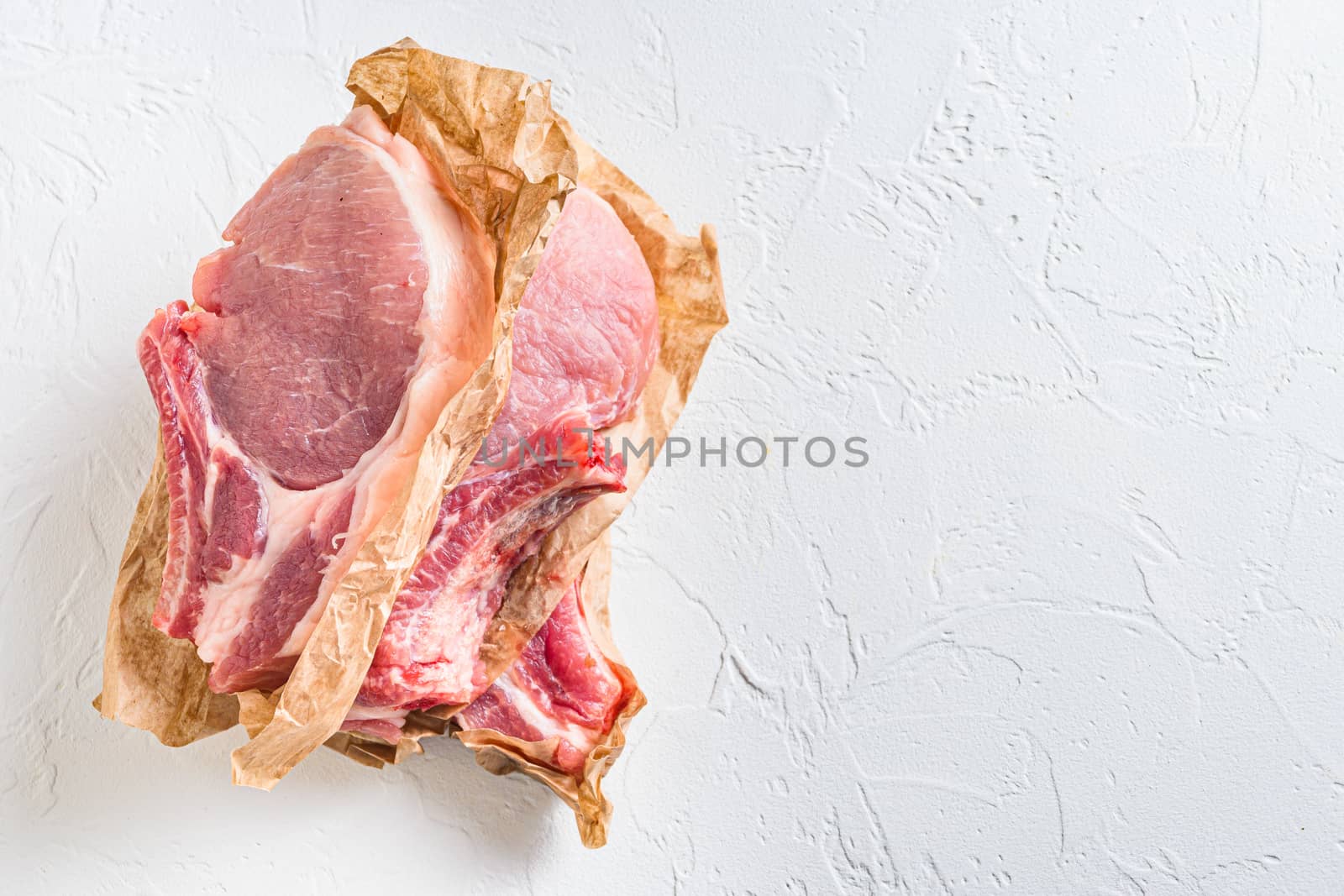 Raw organic bio Pork Belly grill. from above view on white stone background horizontal. Copyspace