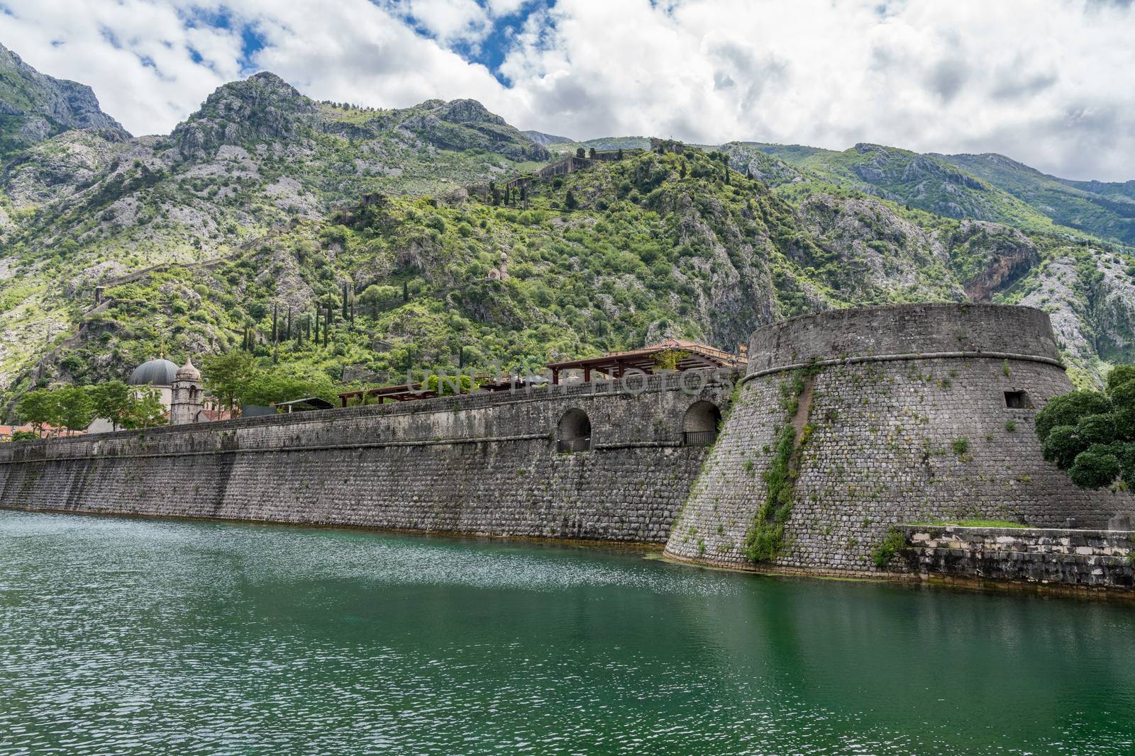 Solid stone walls surround the old town Kotor in Montenegro