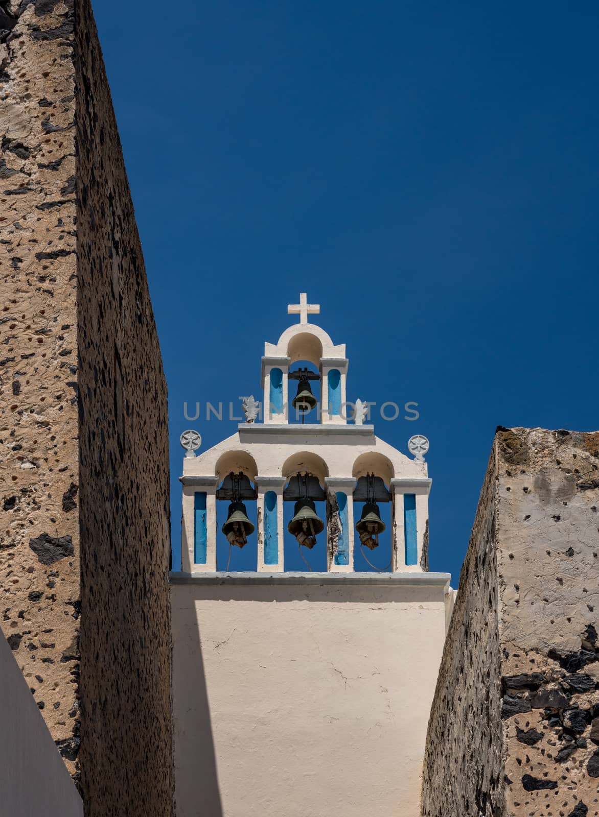 Belltower and bells on Greek Orthodox church in Fira by steheap