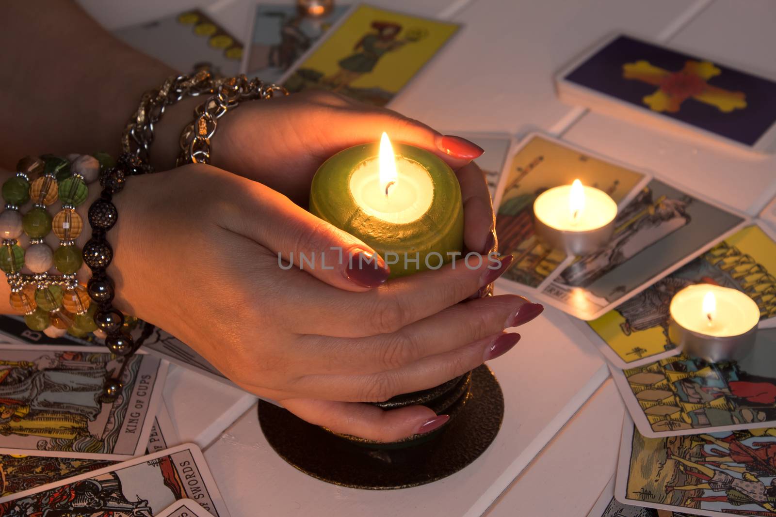 Bangkok,Thailand,March.15.20.Female hands hold a lighted candle  by YevgeniySam