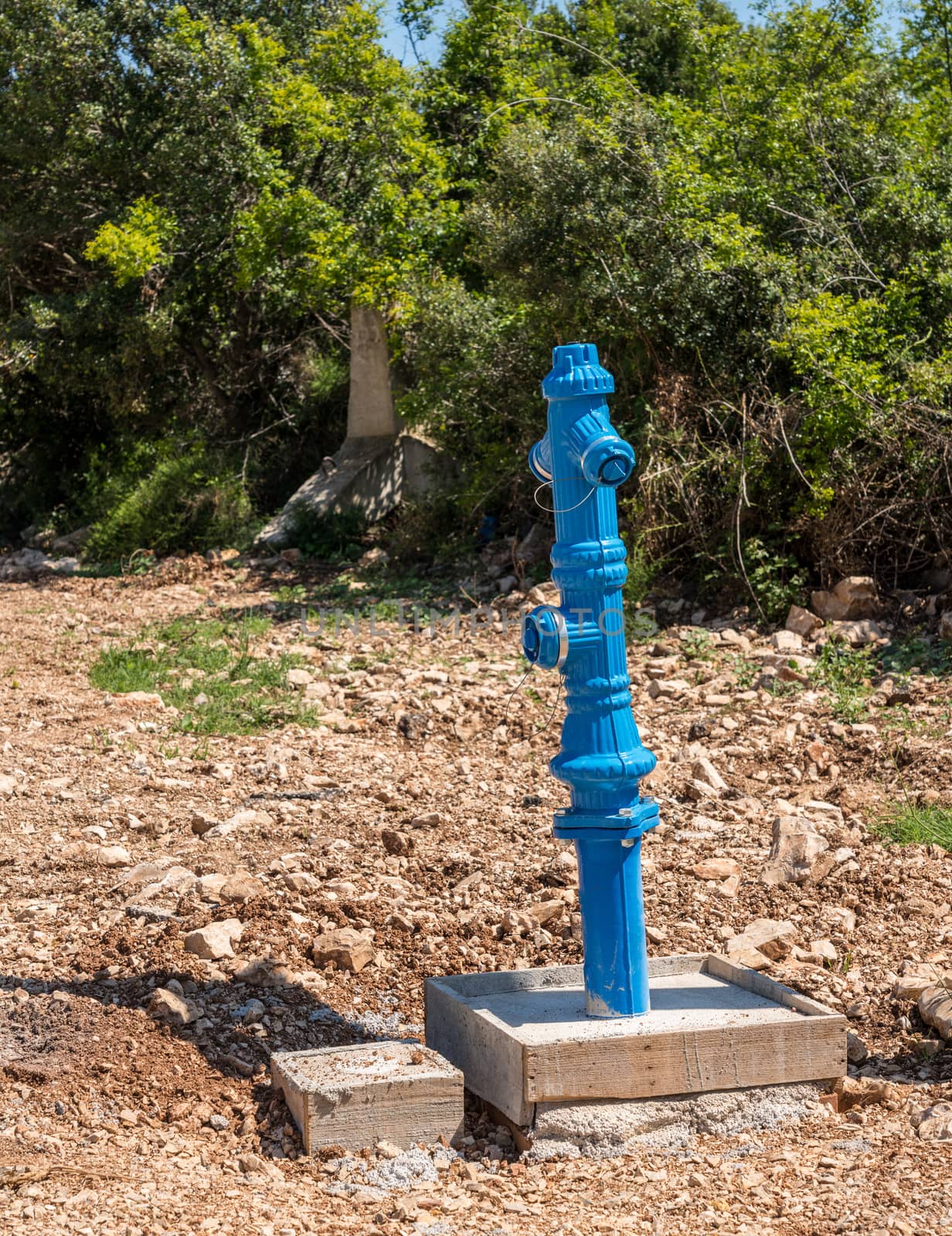 New installation of a blue fire hydrant in country road in Croatia